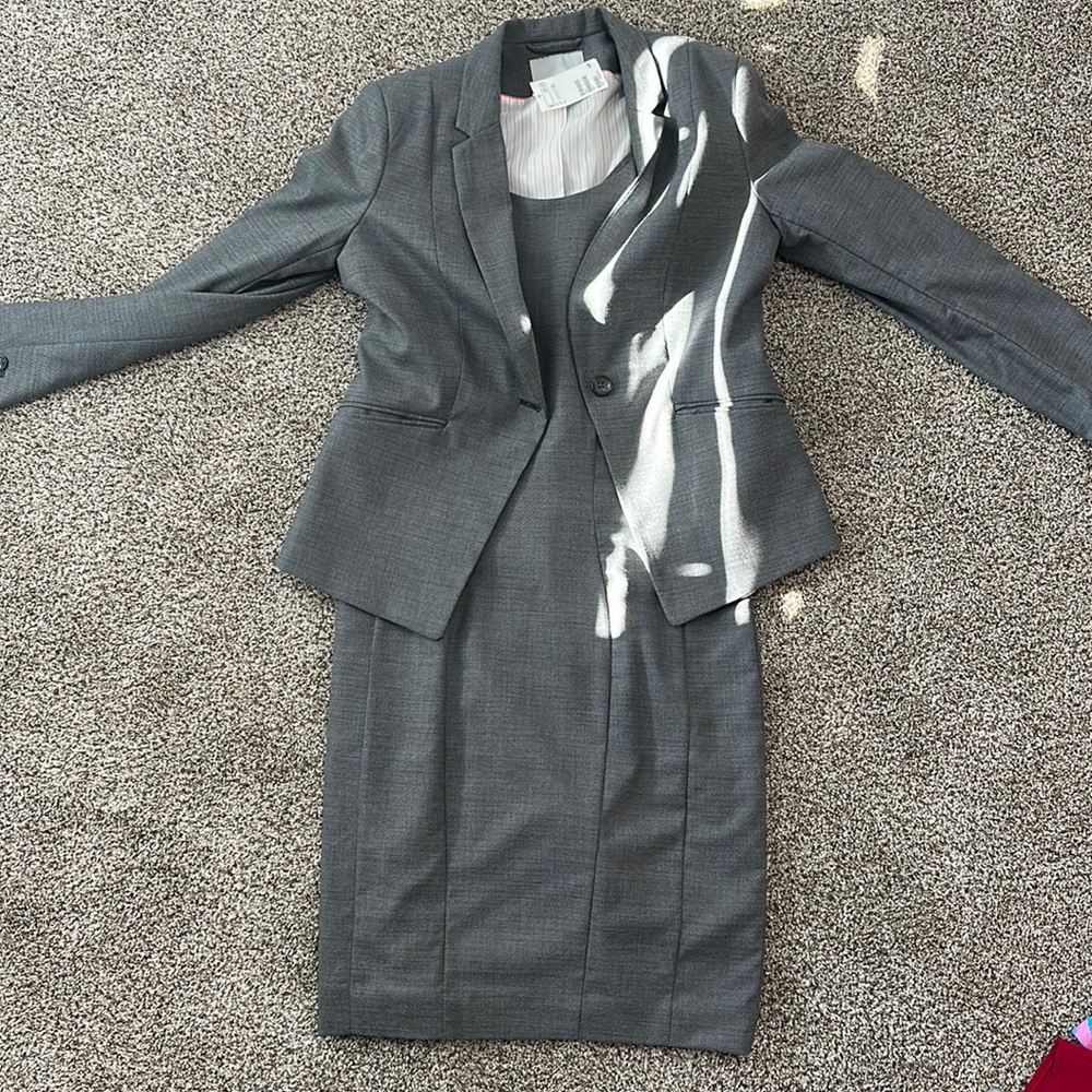 Gray suit jacket and dress. Never worn with tags attached. Size 12
